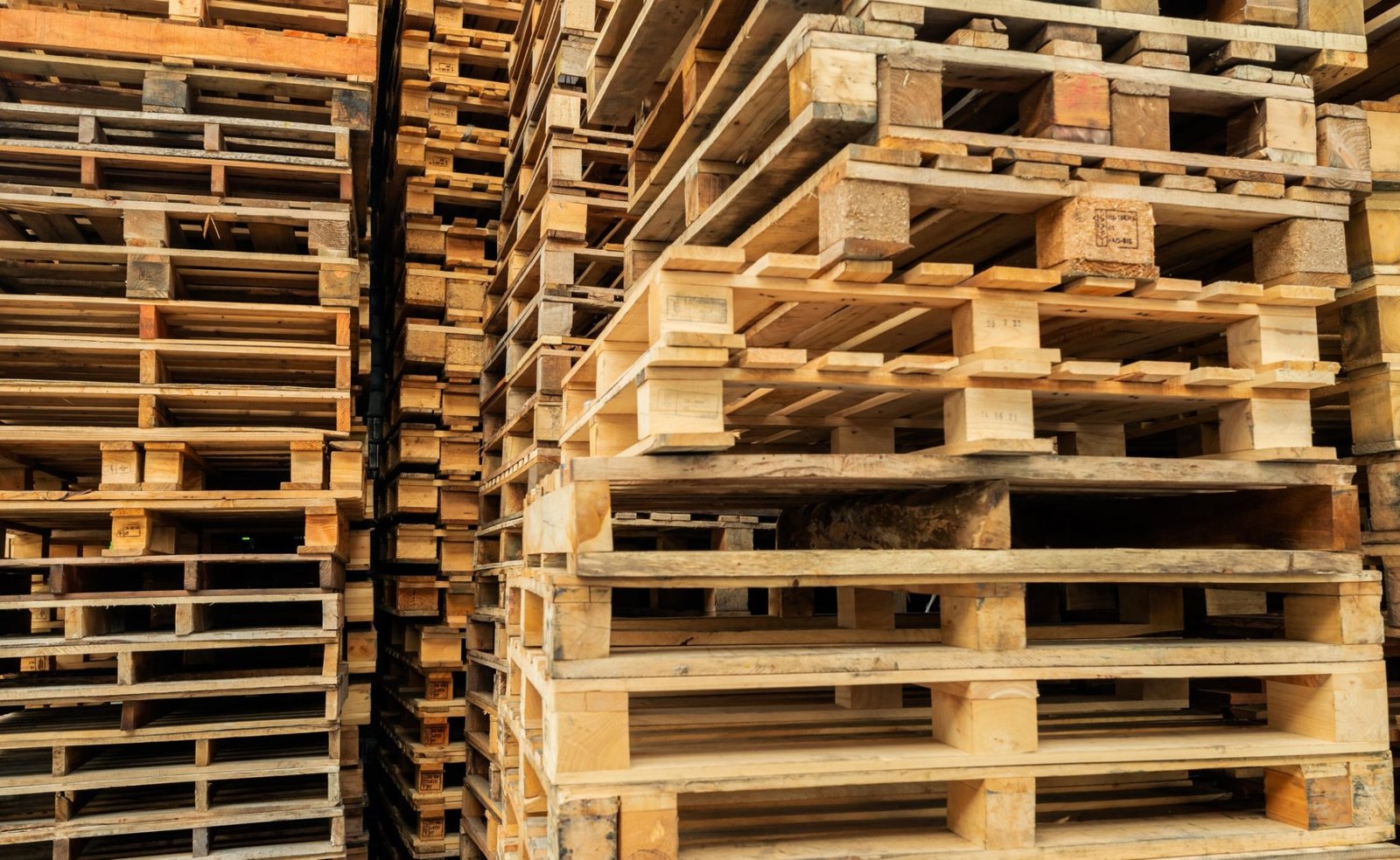 stack-of-wooden-pallet-industrial-wood-pallet-at-factory-warehouse-cargo-and-shipping-concept_t20_QJbBKy-scaled